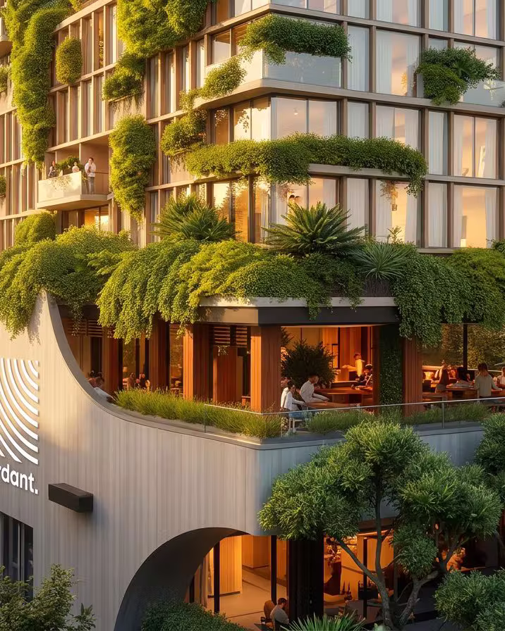 A Verdant tower: a curved board-formed hempcrete facade carrying the Verdant sign, with planted terraces spilling over a city street.